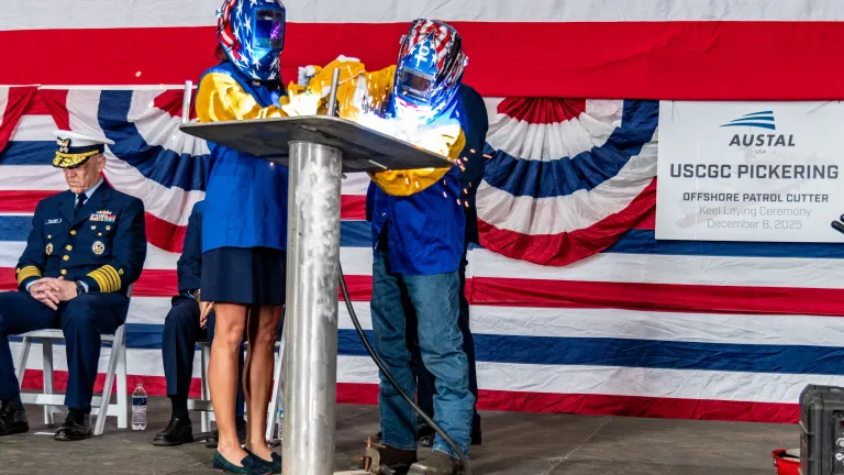 Ship sponsor Dr. Meghan Pickering Seymour welds her initials onto a keel plate during the keel laying ceremony for USCGC Pickering