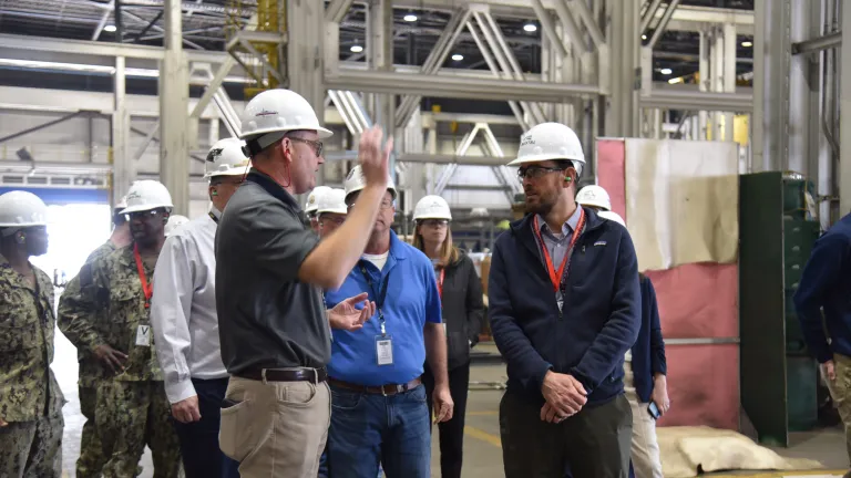 Austal USA interim President discussing the company's shipbuilding process to Mr. Christopher Miller, PAE Maritime