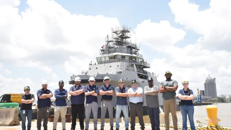 Austal USA's award-winning safety team poses in front of USNS Solomon Atkinson (T-ATS 12)