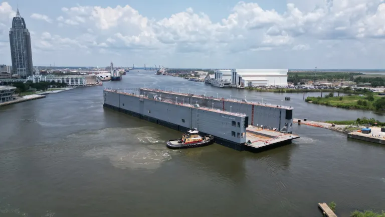 Navy dry dock AFDM 15 moves into place at Austal USA after launch on July 28